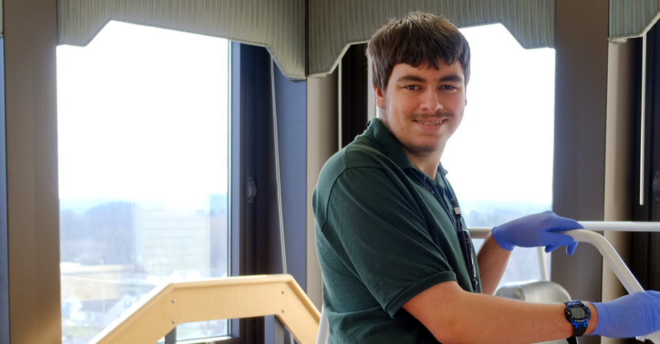 A photo of a Project SEARCH intern cleaning equipment at LMHS.