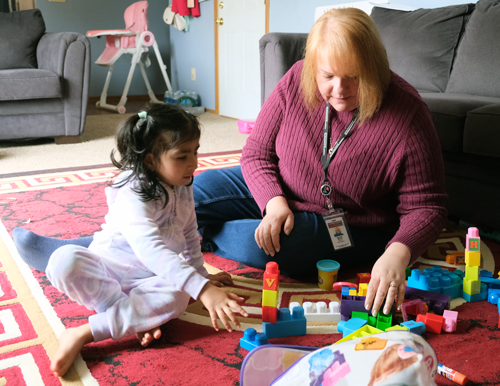 Kripa plays blocks with Service Coordinator Connie Bryant.