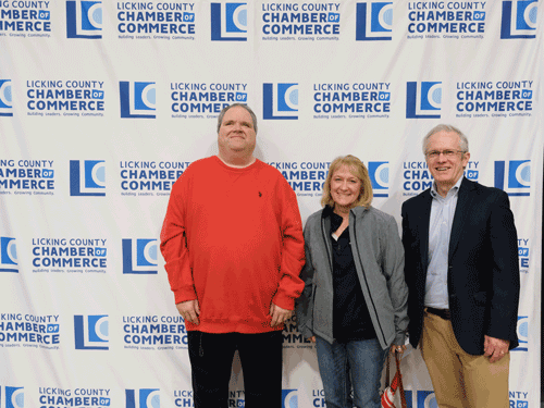 Two LCBDD Board Members and a past Board Member stand in front of a backdrop at the 2025 Groundhog Breakfast.