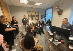 A group of self advocates sit in the office of an Ohio House Representative.